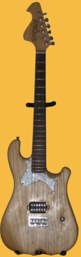 Handmade electric guitar with unfinished wood body, pearloid pickguard, and a single humbucker pickup.